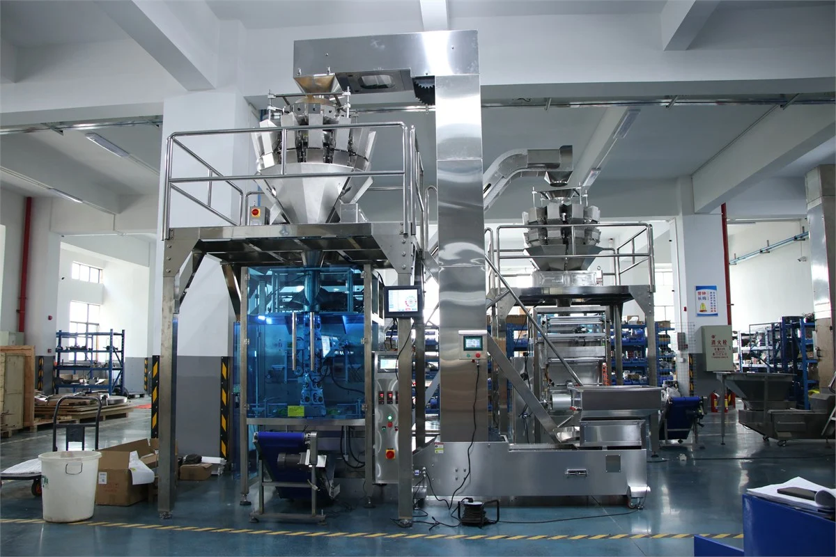 SW-420A collar type multi-head weigher packing machine — full factory floor view with two complete packaging lines