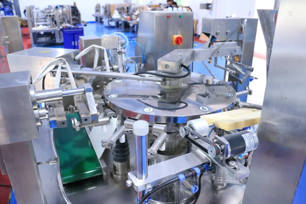 ShengWei Machinery factory floor in Shantou — SW-L200 premade-bag rotary platform during assembly