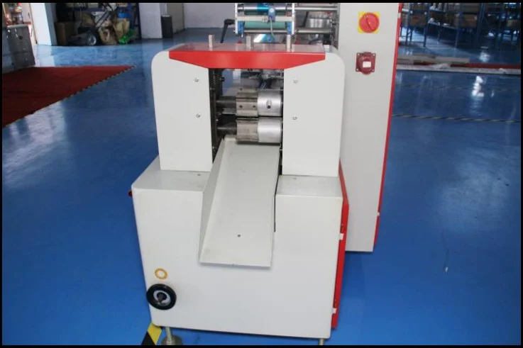 End sealer and outfeed section where finished mixed candy pillow pouches leave the machine