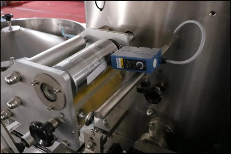 SW-1200 photoelectric colour-mark tracking sensor mounted on film feed roller assembly