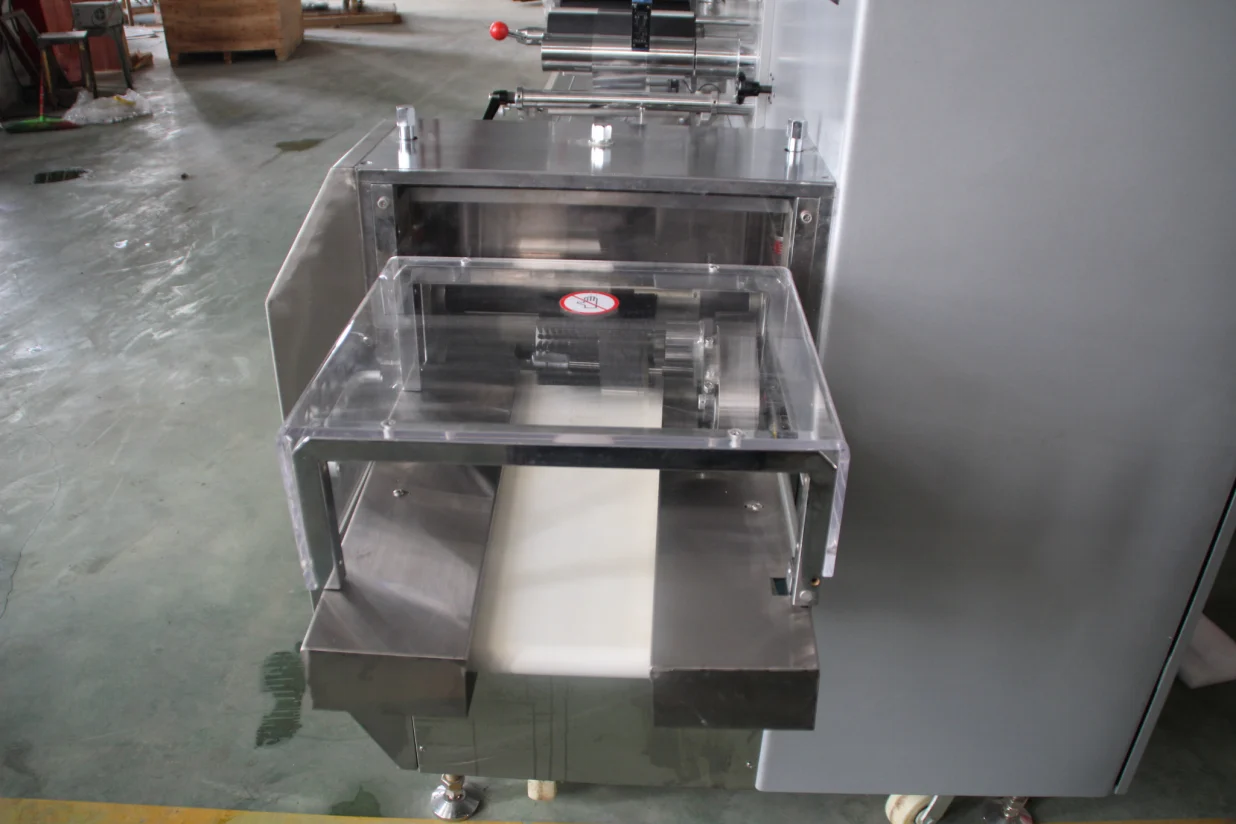 SW-300B end sealer and discharge section with transparent safety cover over the cross seal and cutting zone