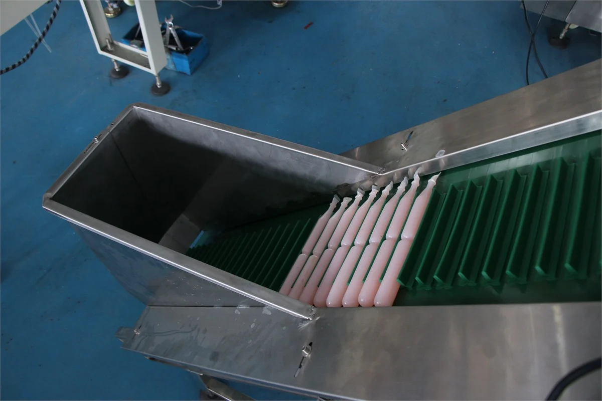 SW-100 ice pop pillow packing machine — film forming shoulder wrapping around the liquid filling tube
