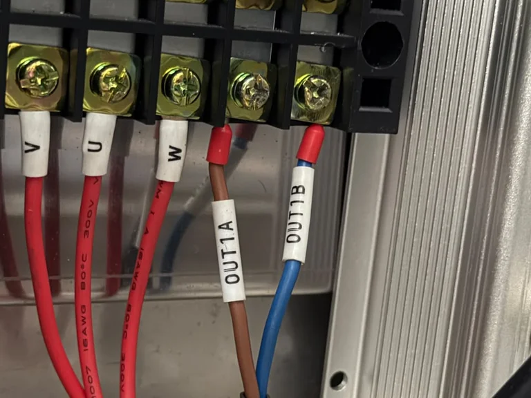 Terminal block with red U, V and W power wires and two signal wires labelled OUT1A and OUT1B