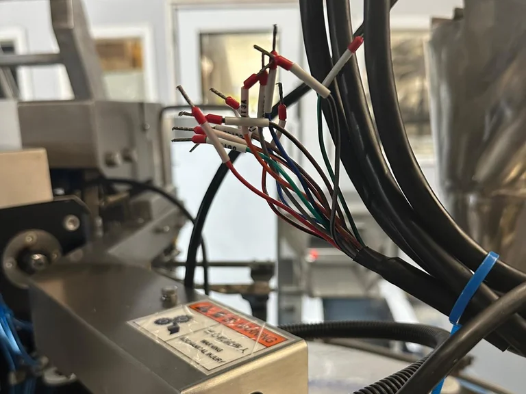 Bundle of cables with ferruled and labelled wire ends waiting for terminal connection on a packing line